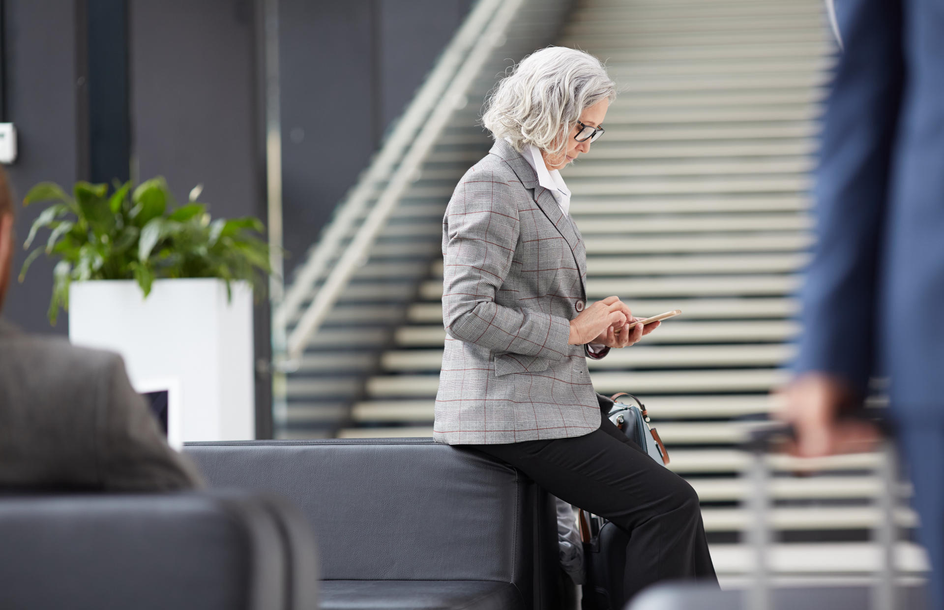 A business person waits to check in at a hotel.