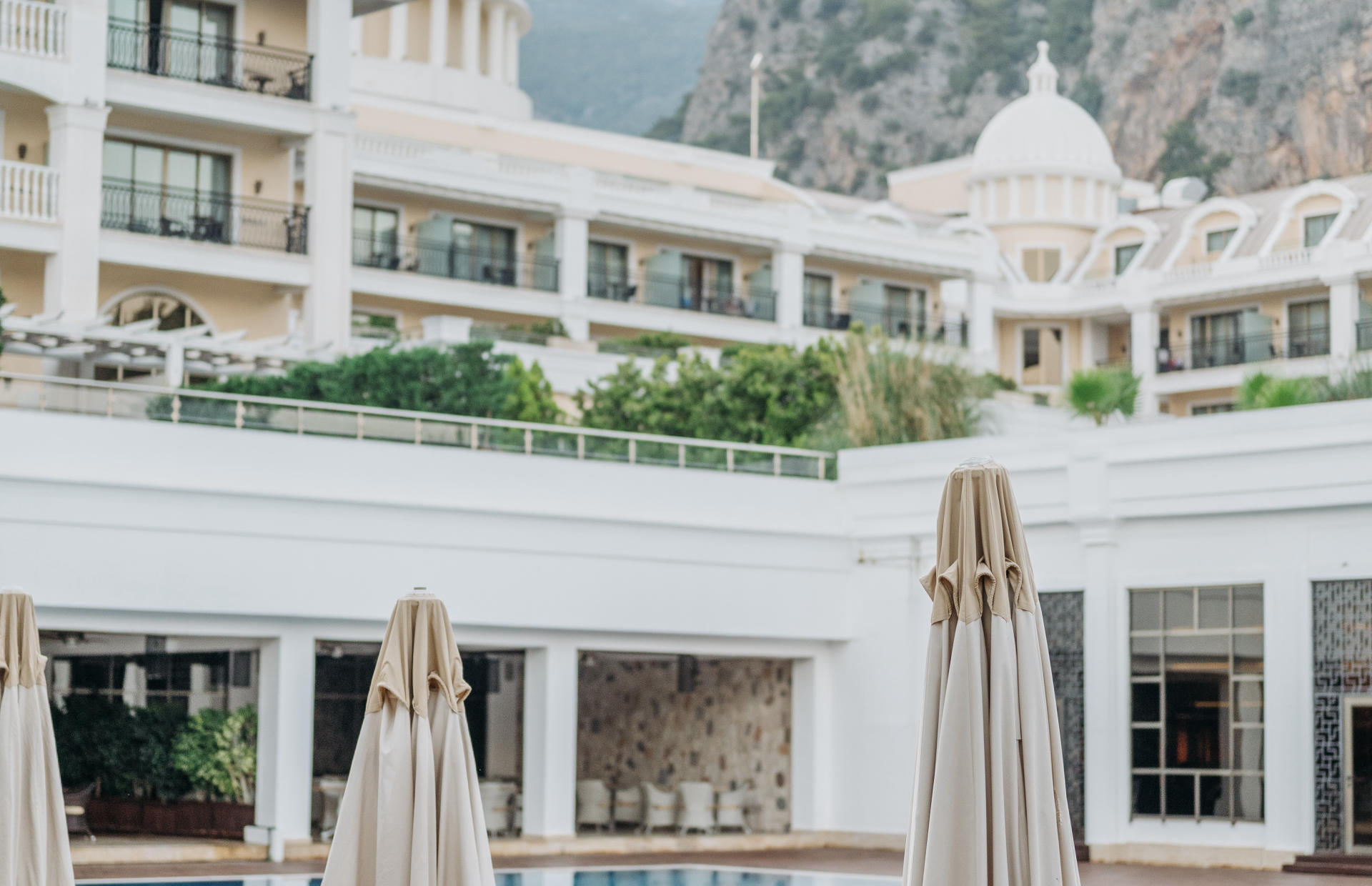 The second-story view of a hotel overlooks the pool.