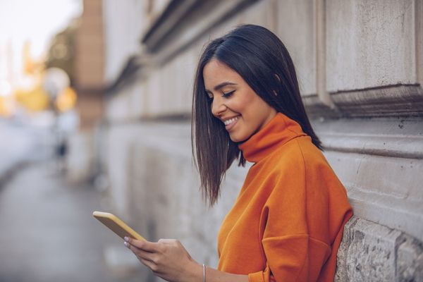 Woman looking at her phone smiling