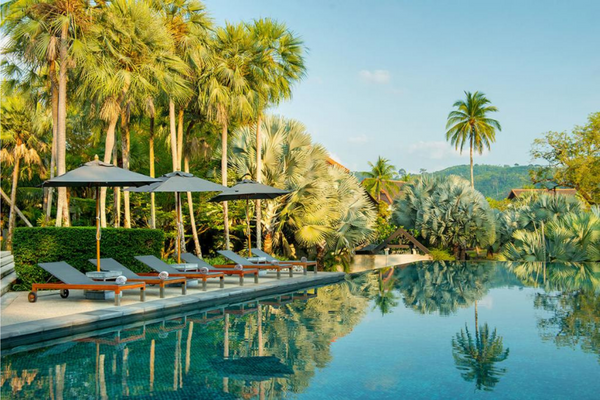 The Slate, a Phuket Pearl Resort, property with poo chairs, palm trees and an infinity pool