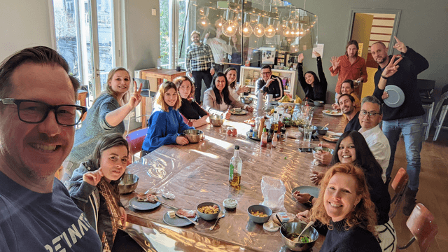 A group of Revinators enjoy a meal together around a large table. 