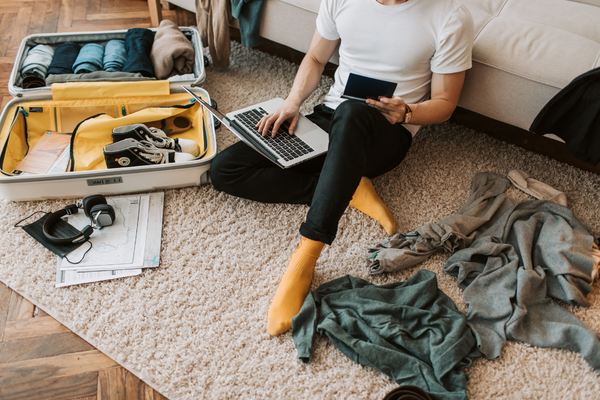 person packing while looking at their laptop